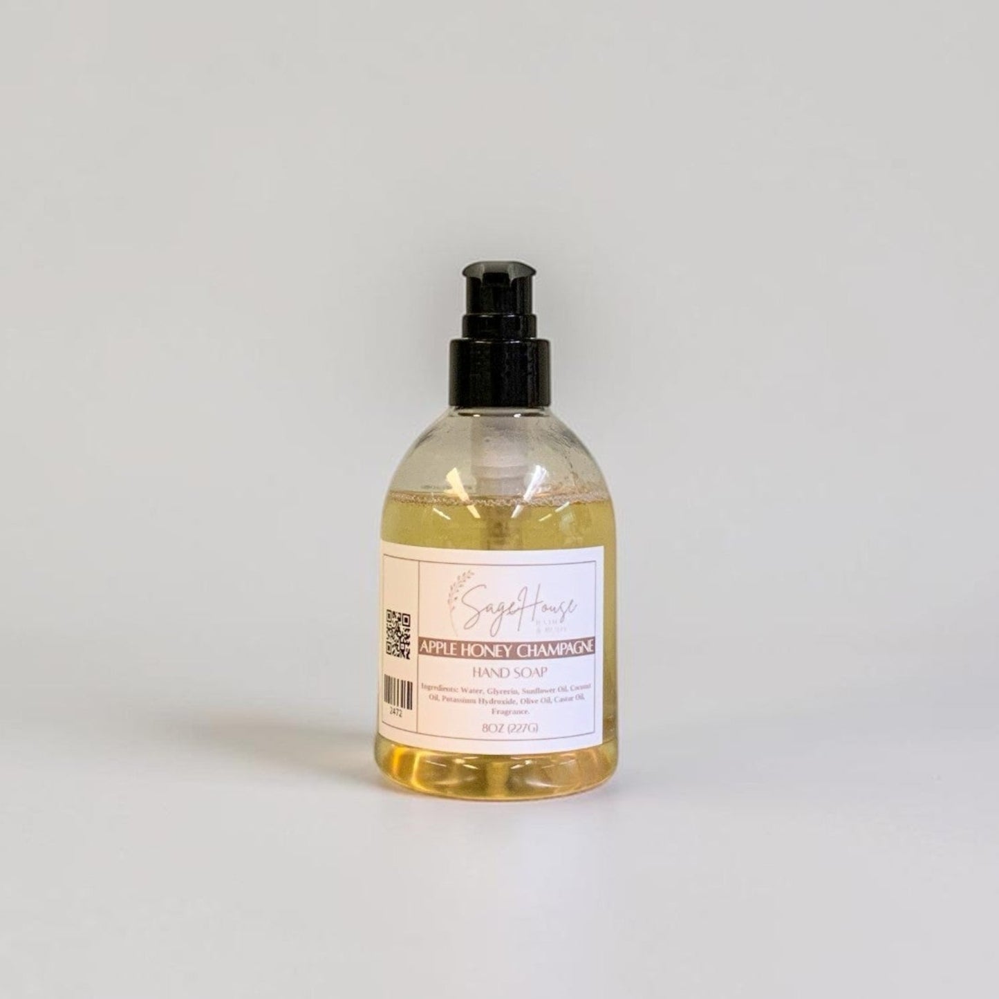 A bottle with black pump top and white label. On a white background.