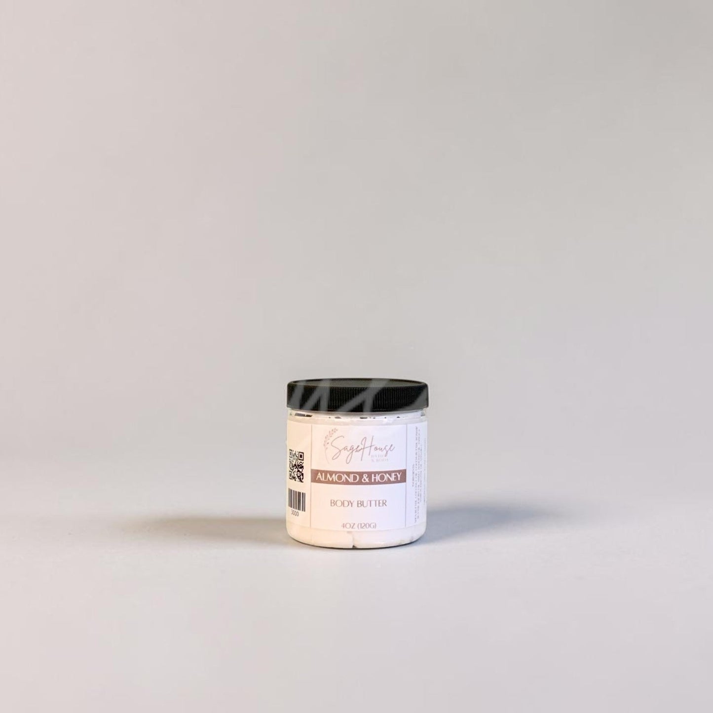 White jar with black lid on a light gray background