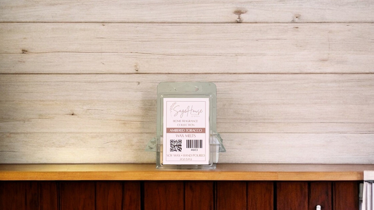 A clear clamshell container holding 6 wax melt cubes with a label on top, placed on a wooden surface against a wooden background.