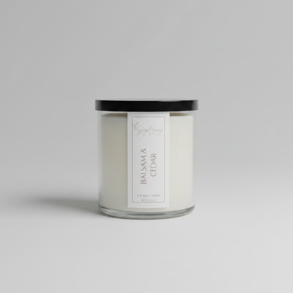 A white soy wax candle in a clear container, placed on a wooden surface, with a label on the front.