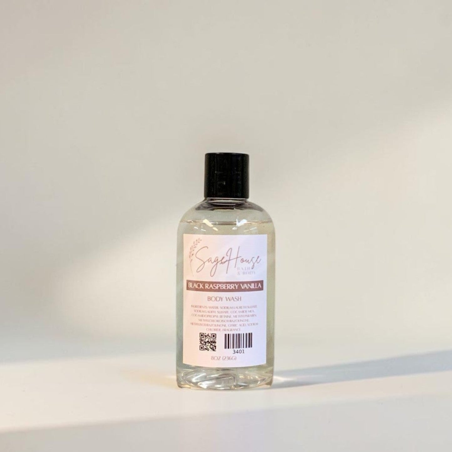 Clear bottle with black cap on a light gray background