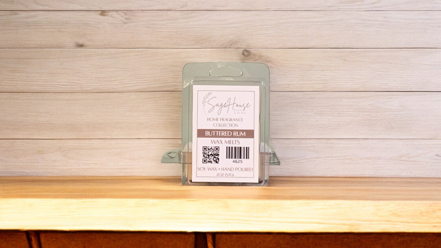 A clear clamshell container holding 6 wax melt cubes with a label on top, placed on a wooden surface against a wooden background.