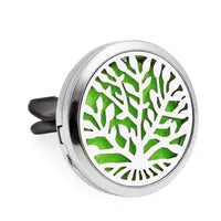 A car vent clip with a design that resembles a tree or leaf, primarily in green and black colors.