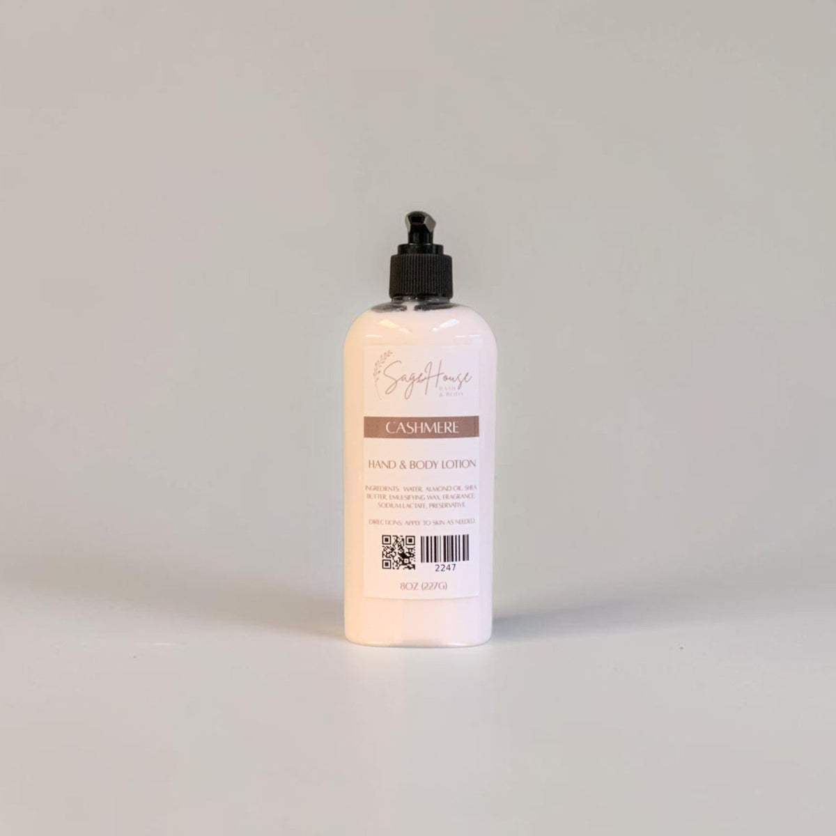 A large bottle of lotion with black pump top and white label. On a white background.