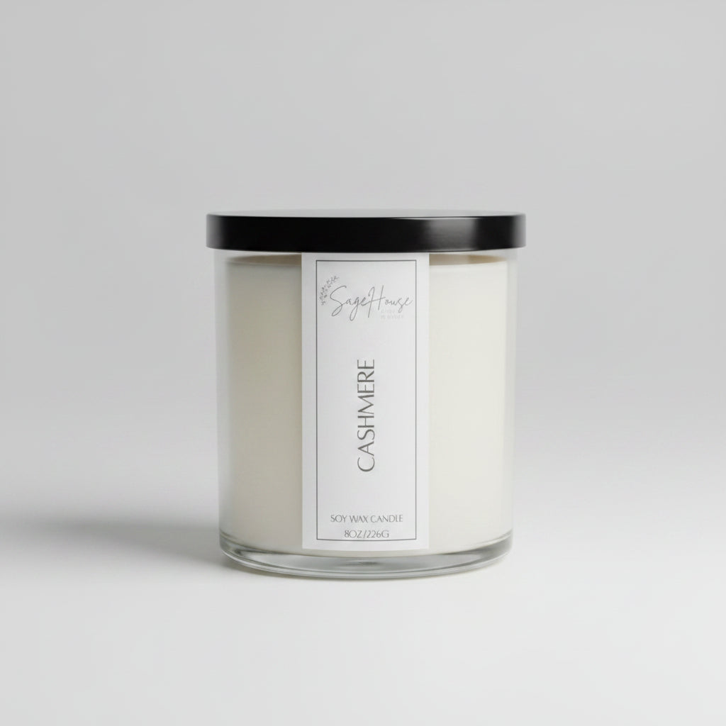 A white soy wax candle in a clear container, placed on a wooden surface, with a label on the front.