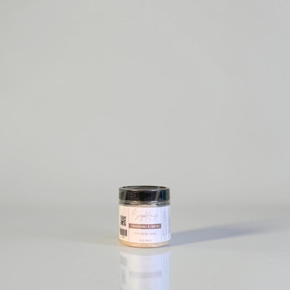 A jar with black lid and white label. On a white background.
