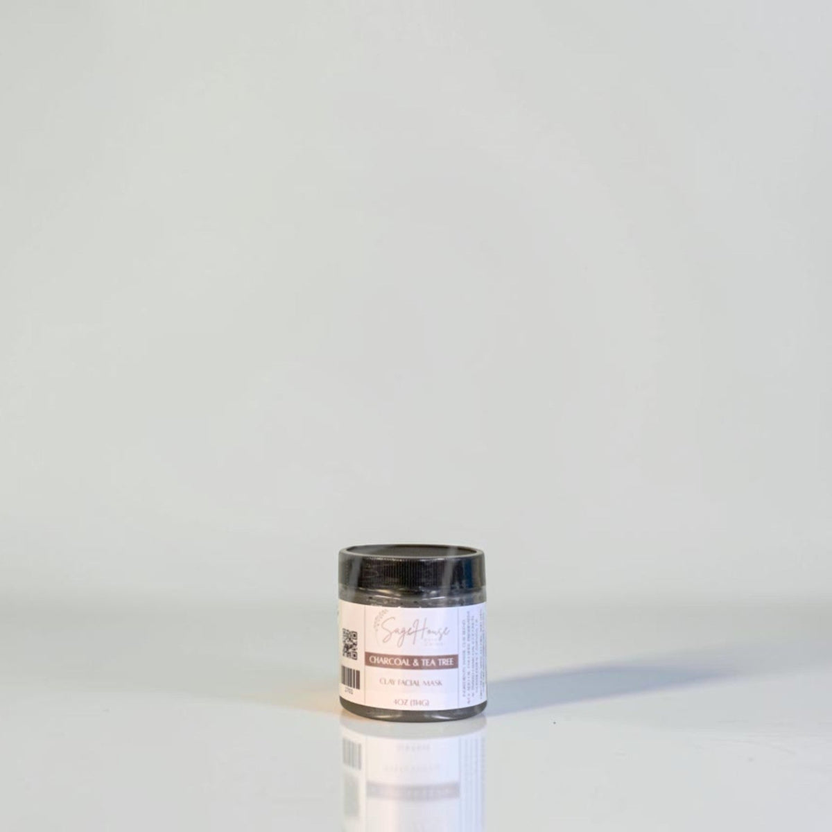 A jar with black lid and white label. On a white background.