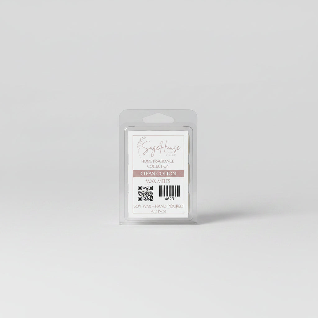 A clear clamshell container holding 6 wax melt cubes with a label on top, placed on a wooden surface against a wooden background.