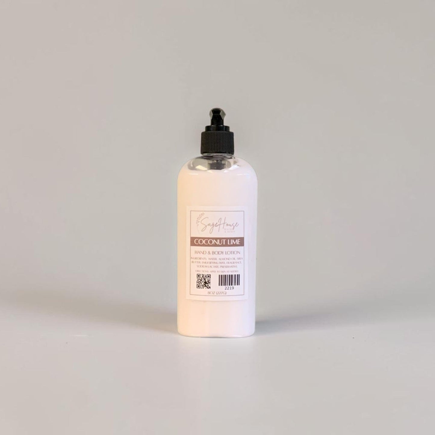 A large bottle of lotion with black pump top and white label. On a white background.