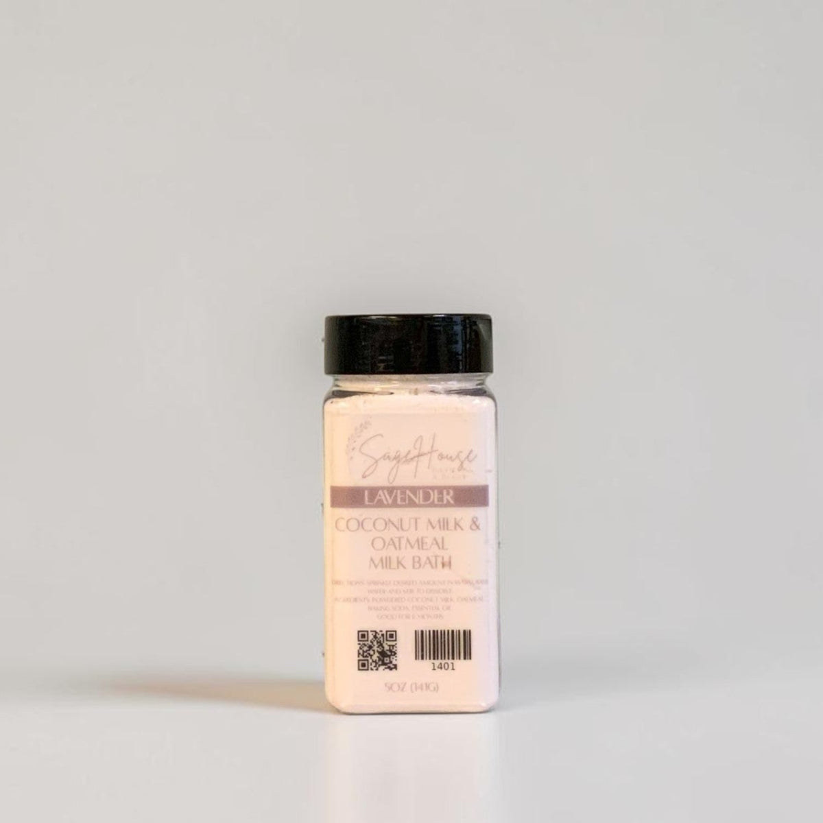 A bottle of coconut milk bath with a black cap and label. On a light gray background.