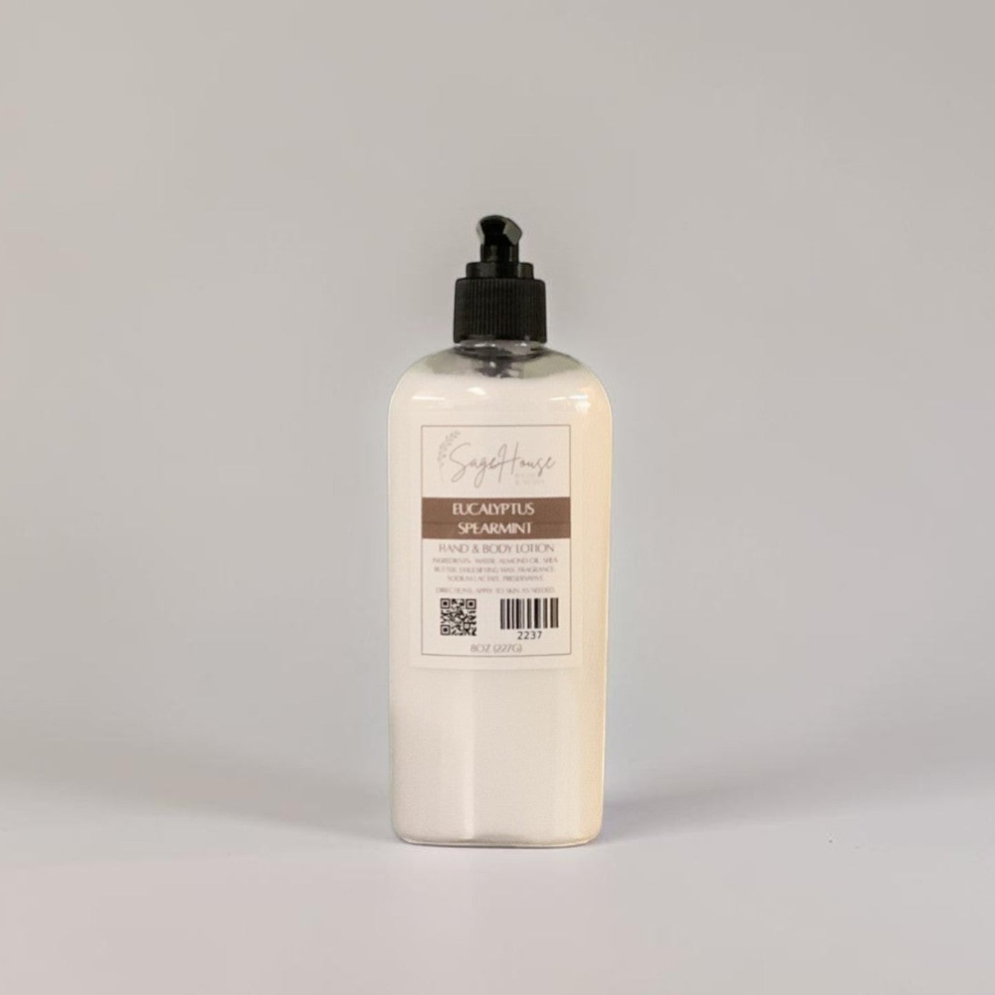 A large bottle of lotion with black pump top and white label. On a white background.