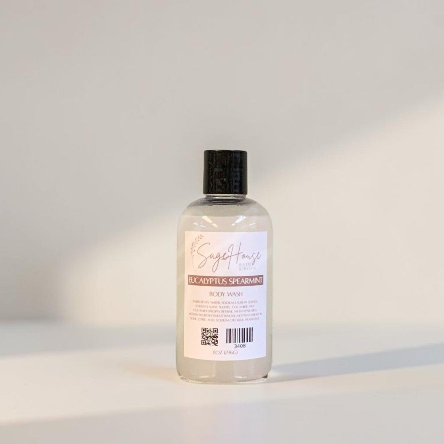 Clear bottle with black cap on a light gray background