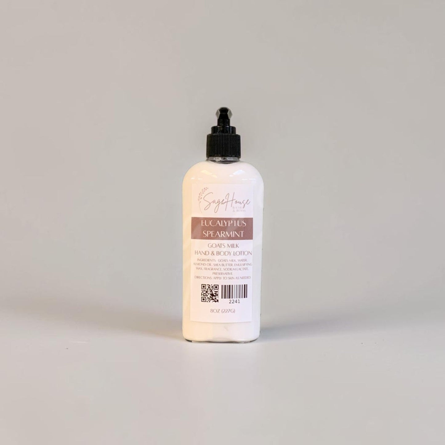 A large bottle of lotion with black pump top and white label. On a white background.