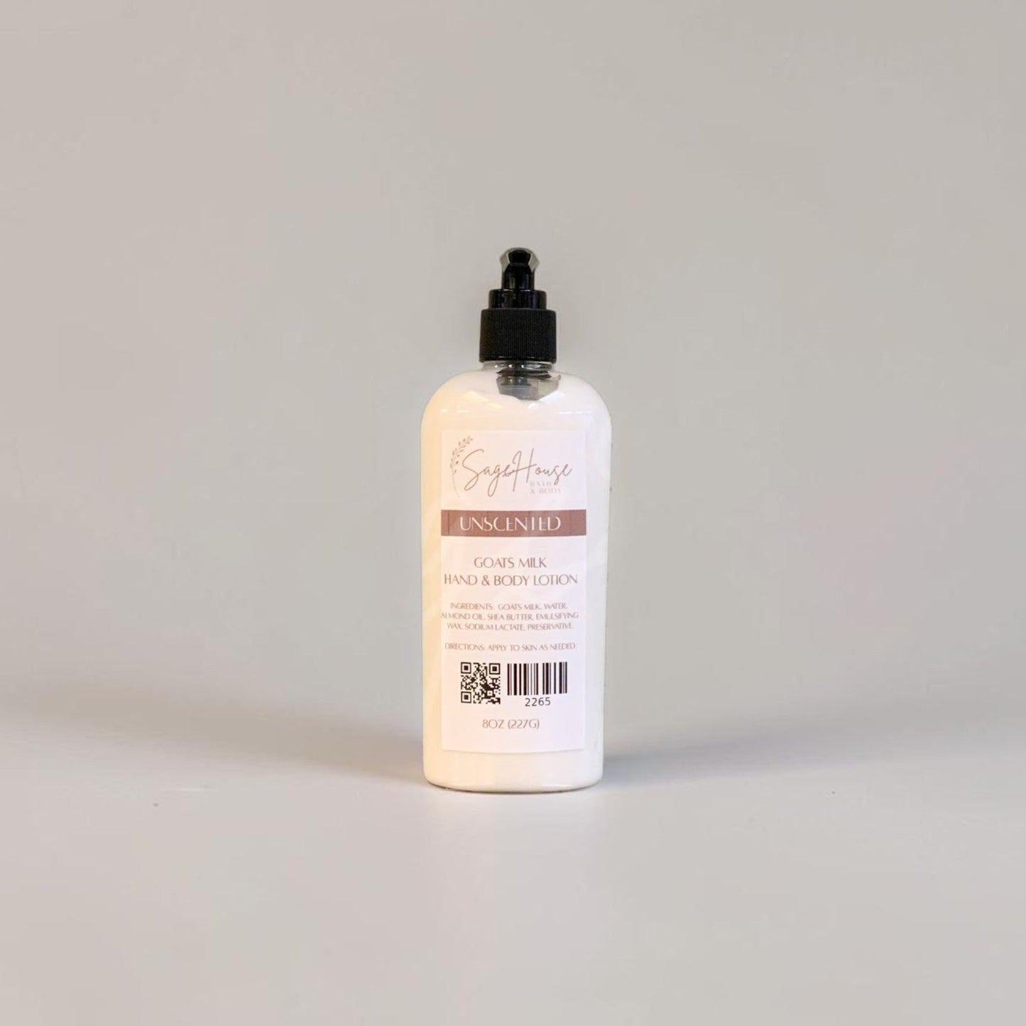 A large bottle of lotion with a black pump top and white label. On a white background.