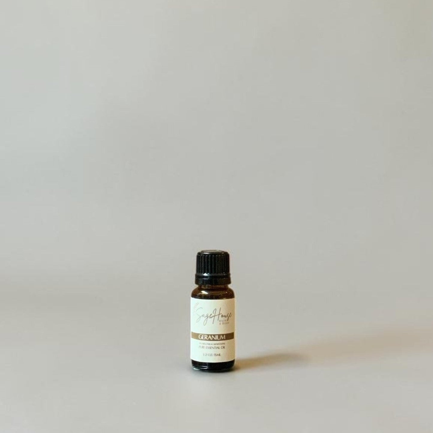 Bottle of Essential oil on a grey background.