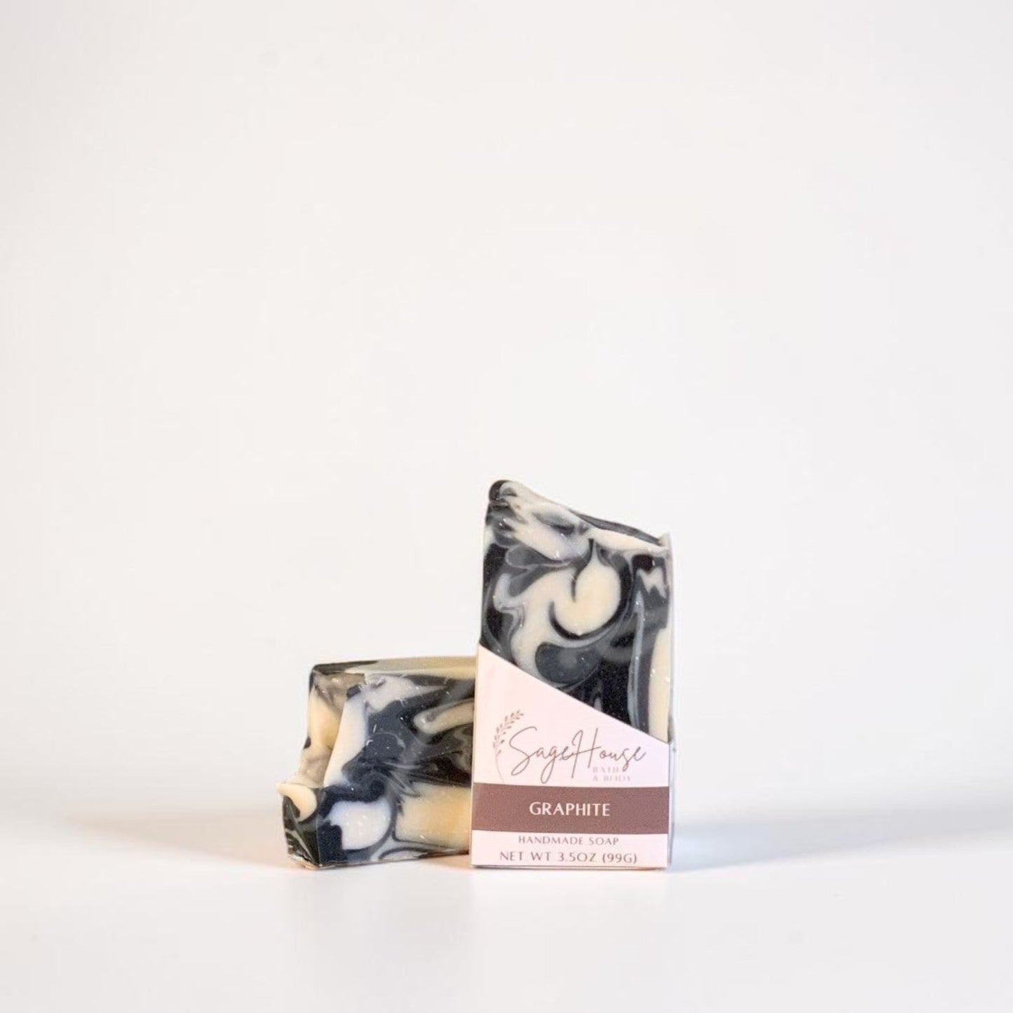 A labeled bar of soap sitting in front of a matching bar. On a white background.