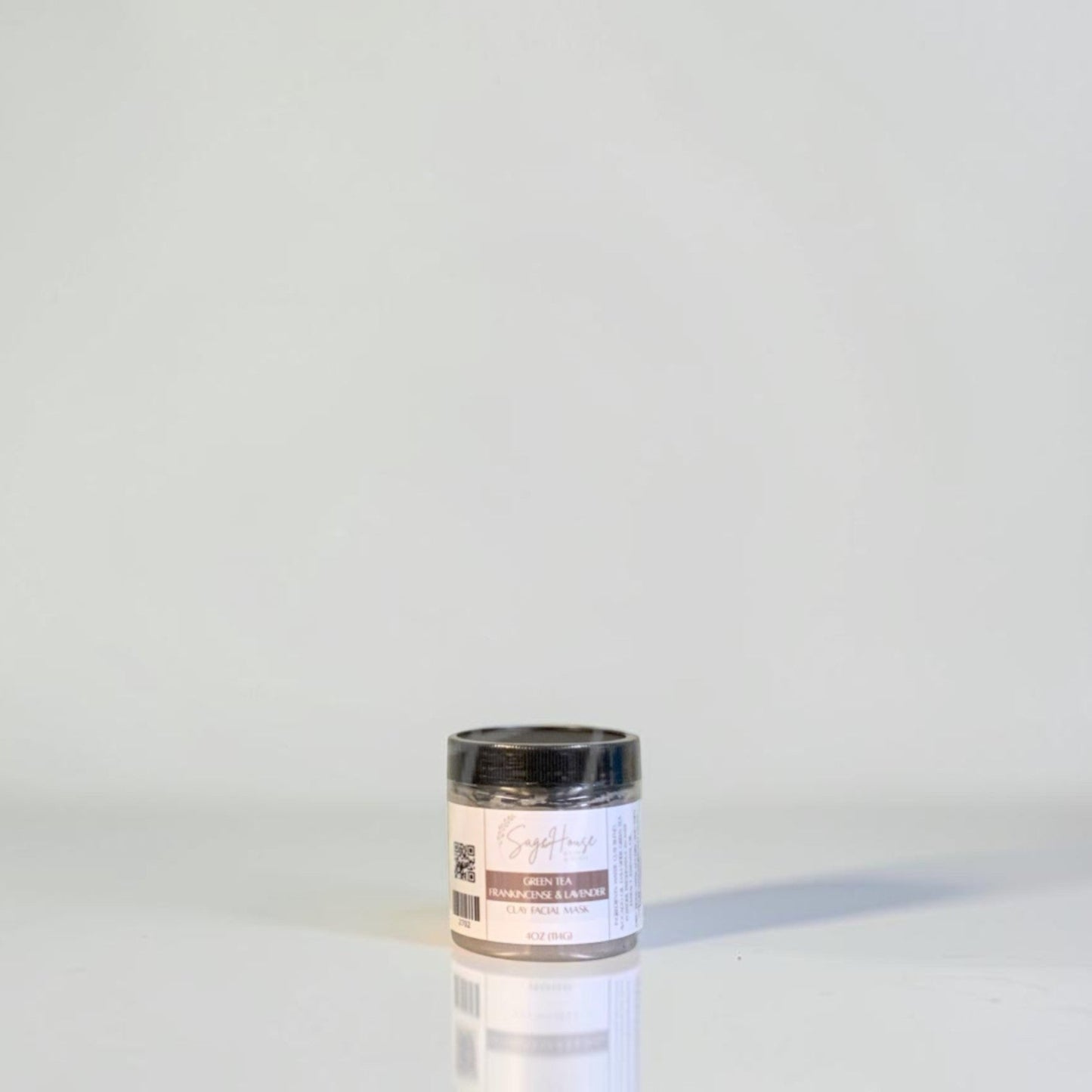 A jar with black lid and white label. On a white background.