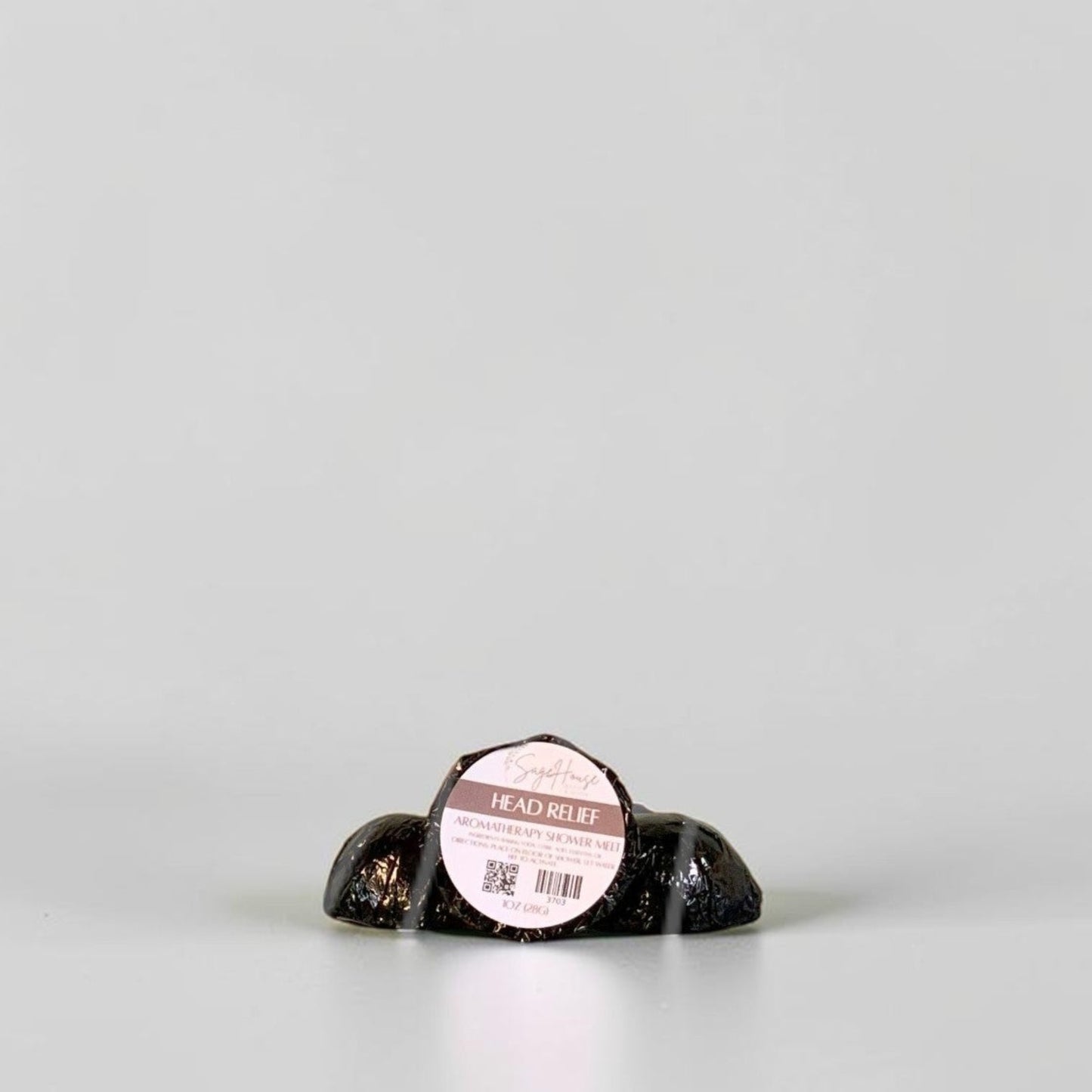 One labeled shower melt propped in front of 2 other shower melts. Sitting on a white background.
