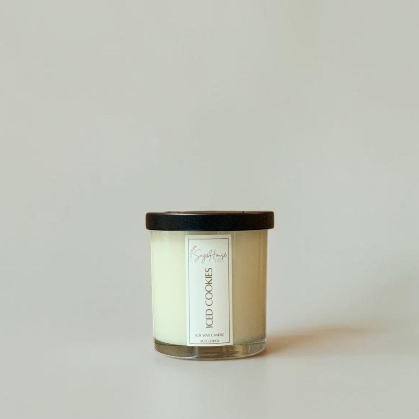 Candle with a label on a plain background