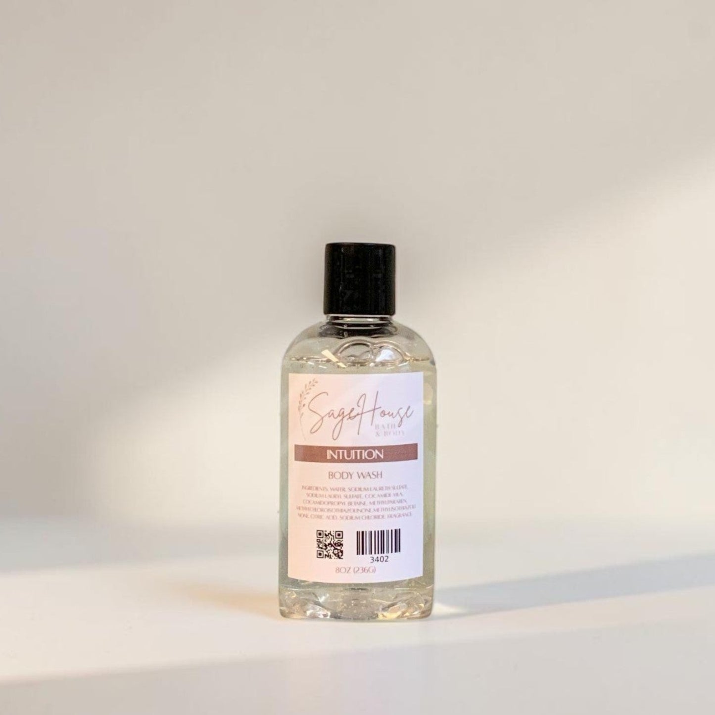 Clear bottle with black cap on a light gray background