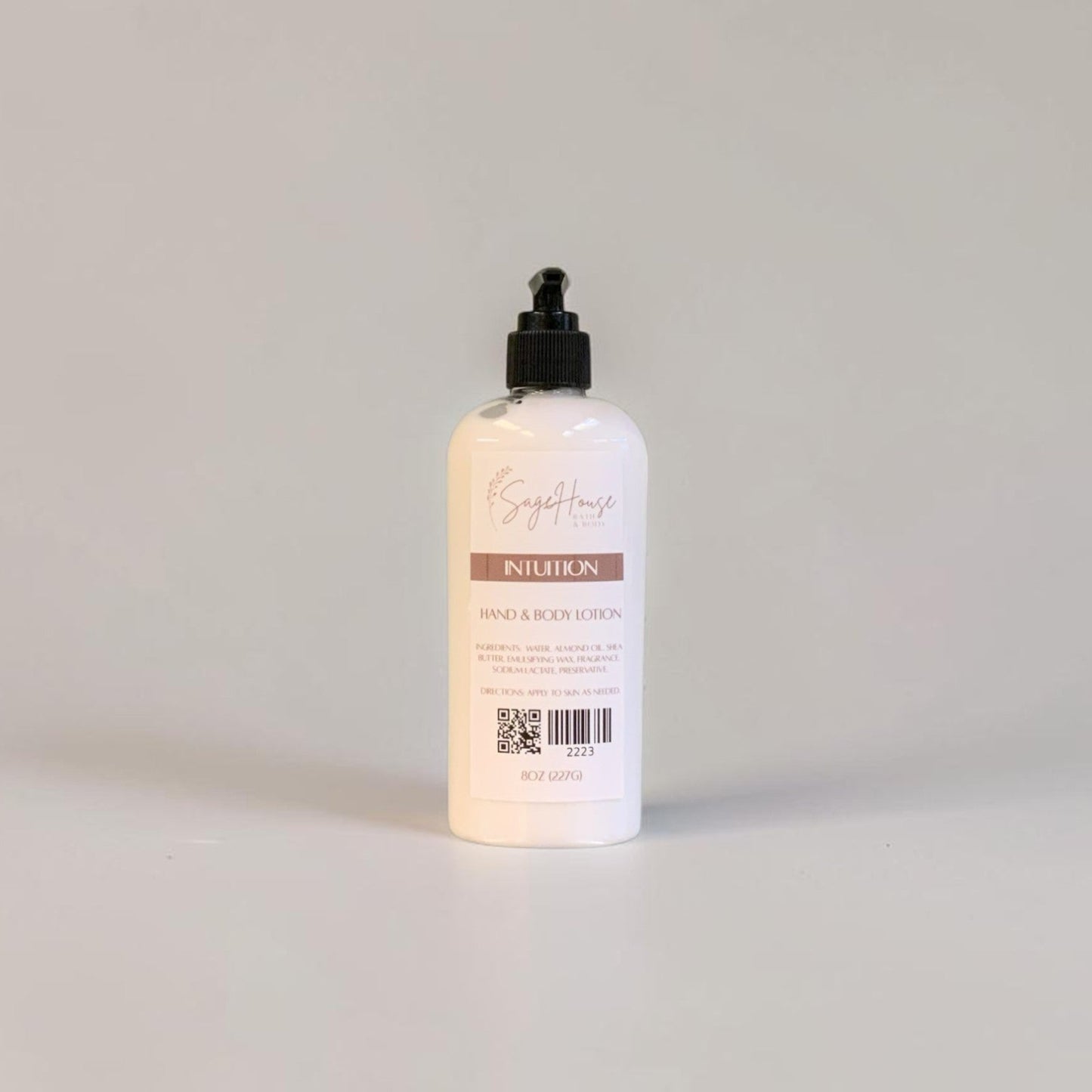 A large bottle of lotion with black pump top and white label. On a white background.