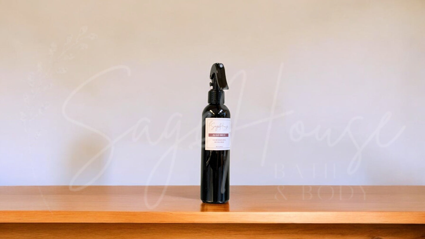 Black spray bottle with a label, on a wooden surface against a white textured wall.