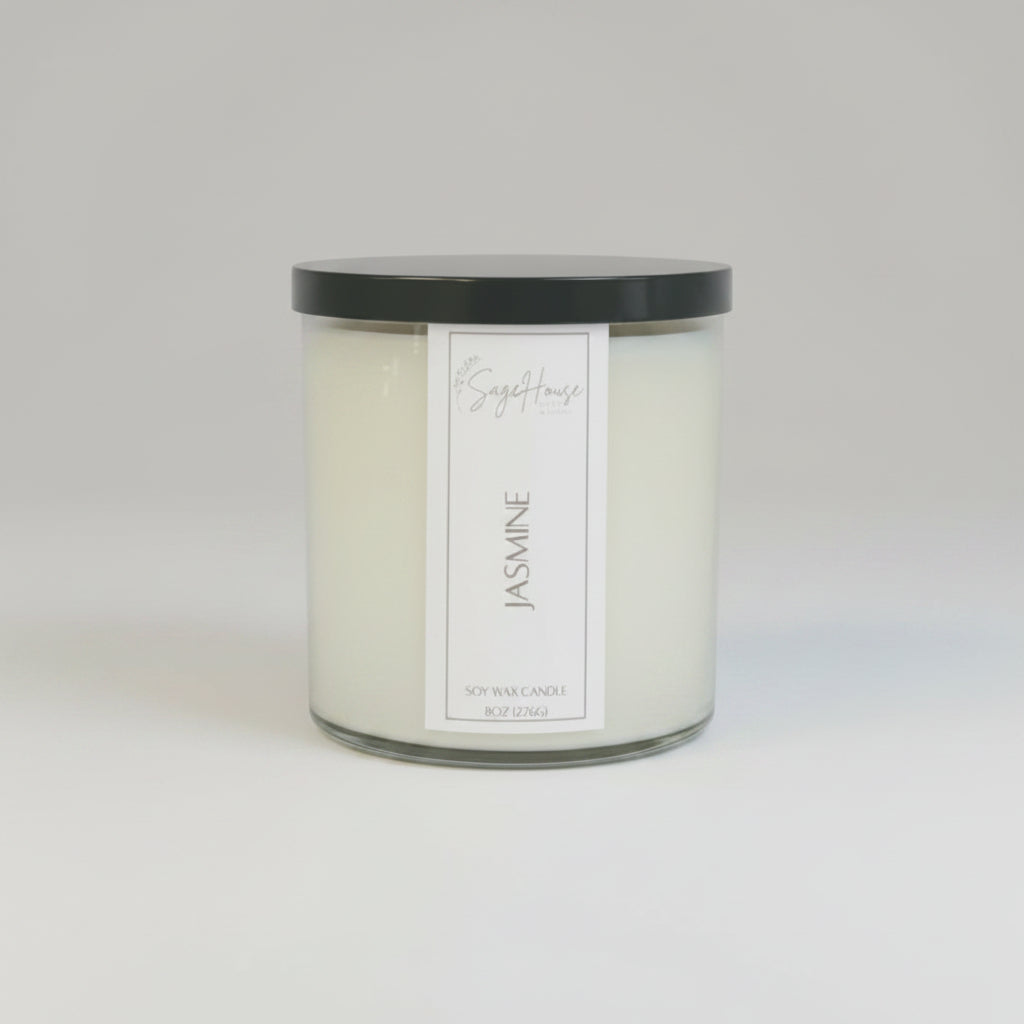 A white soy wax candle in a clear container, placed on a neutral background.