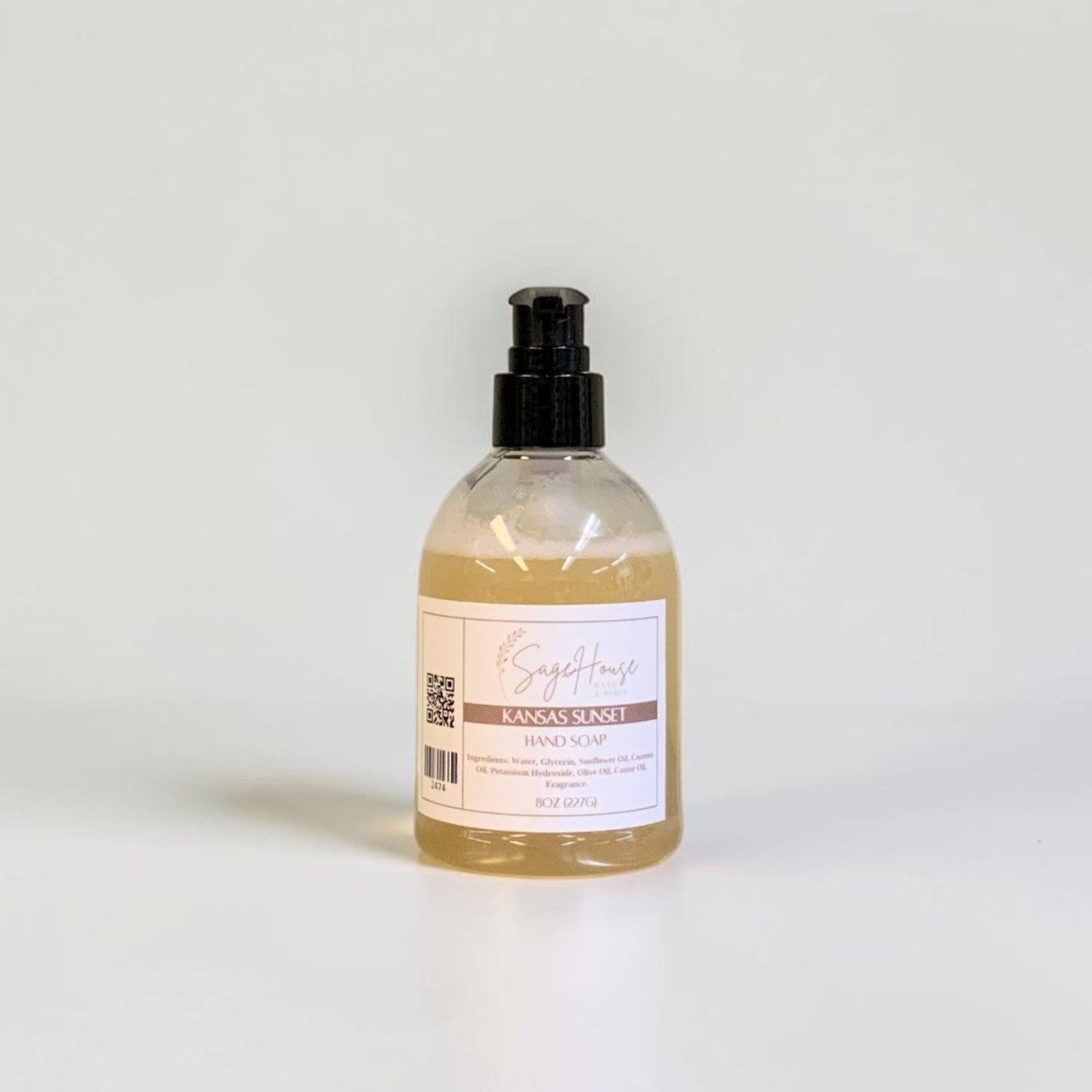 A bottle with black pump top and white label. On a white background.