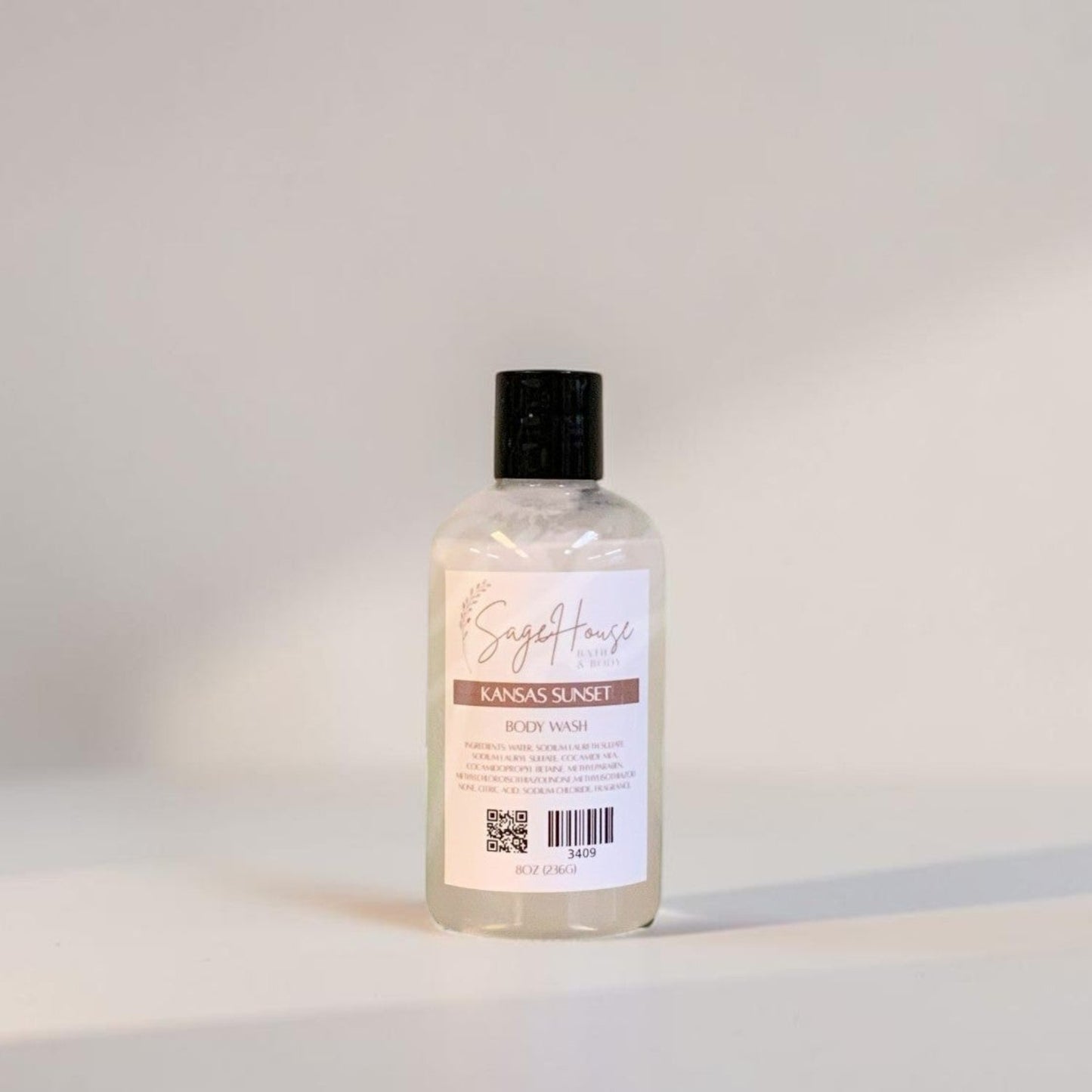 Clear bottle with black cap on a light gray background