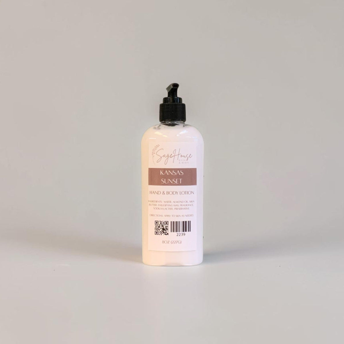 A large bottle of lotion with black pump top and white label. On a white background.