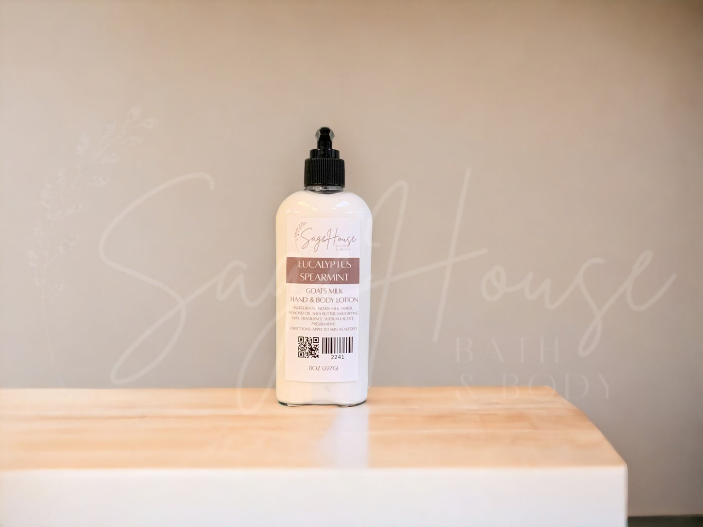 A Large bottle of lotion with black pump top, on a wooden surface with a neutral background