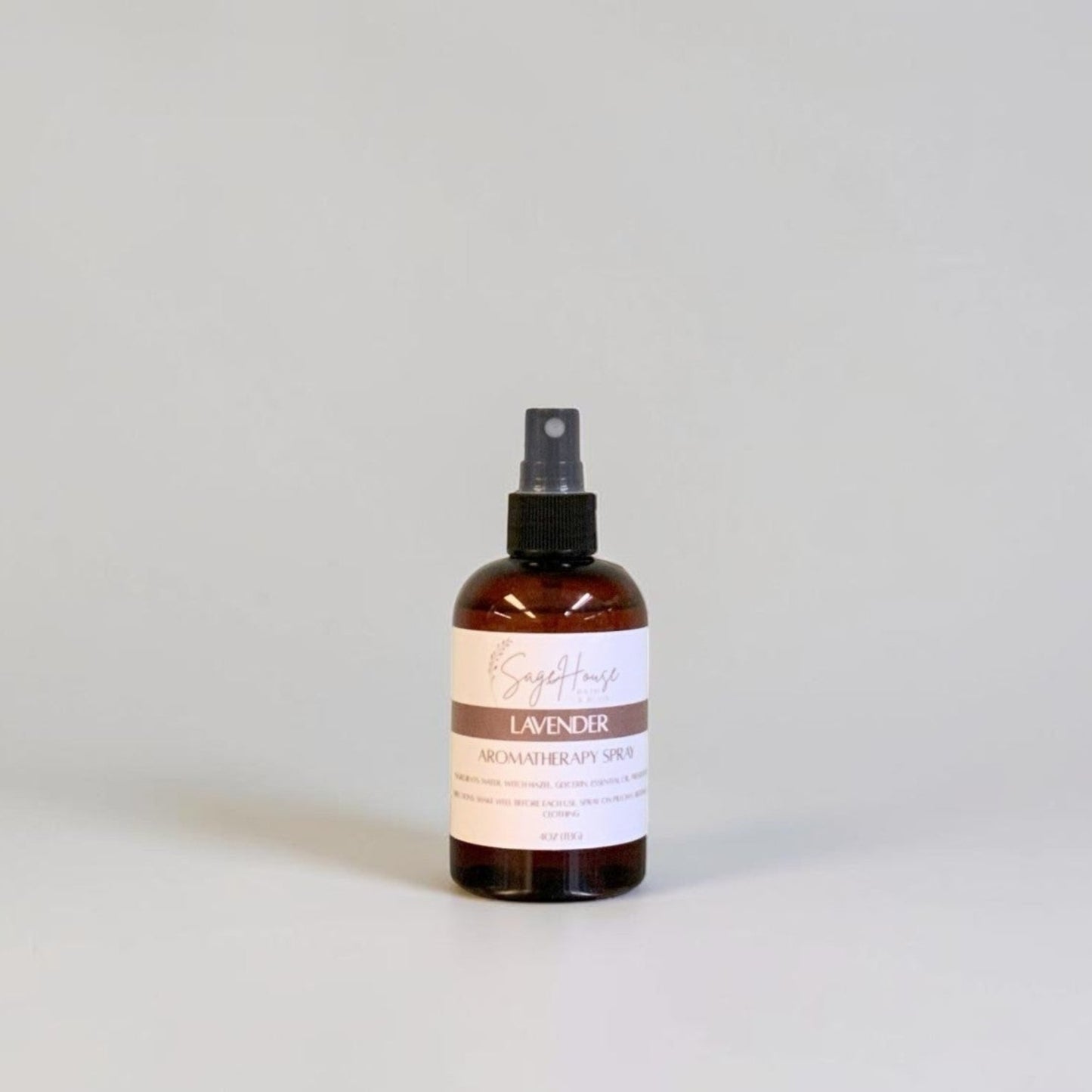 Brown spray bottle with a label on a light gray background