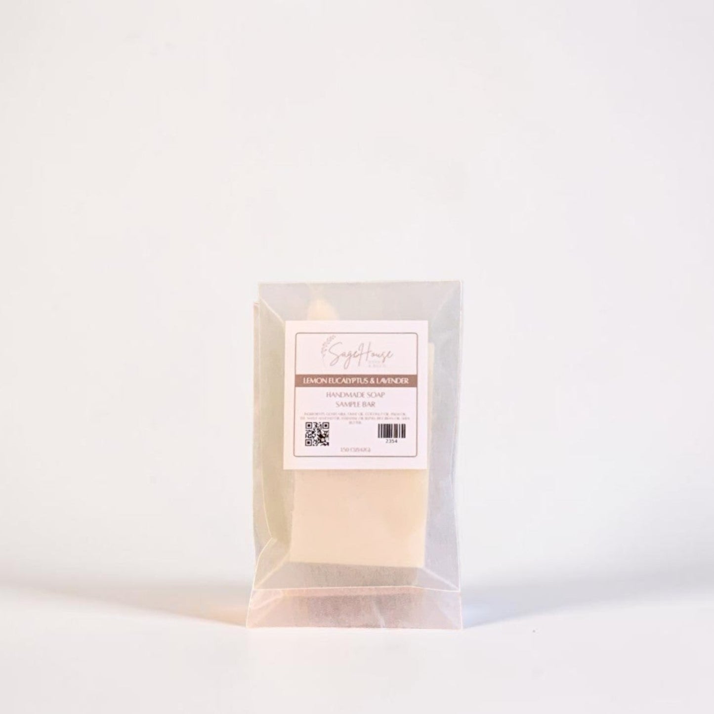 A soap sample in a frosted glassine bag with a label. On a white background.