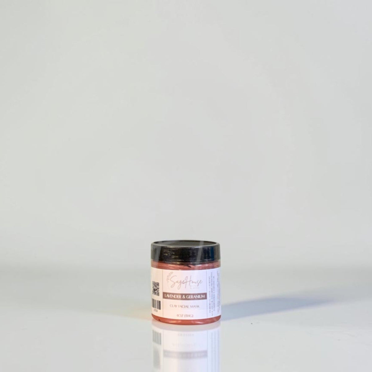 A jar with black lid and white label. On a white background.