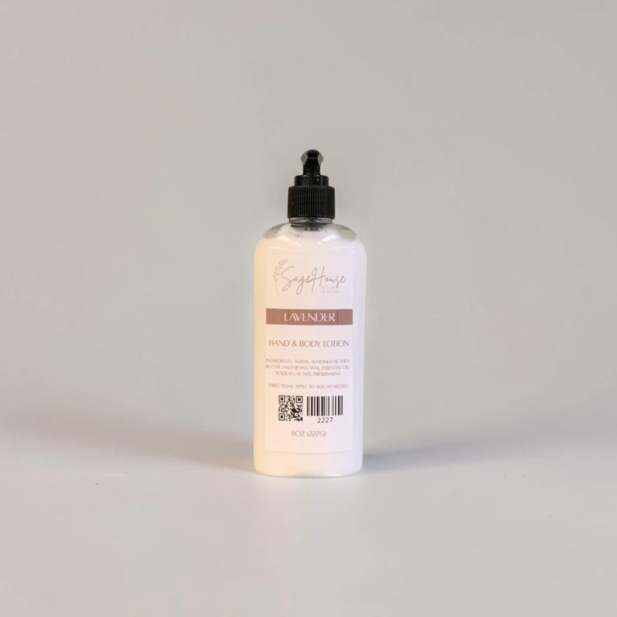 A large bottle of lotion with black pump top and white label. On a white background.