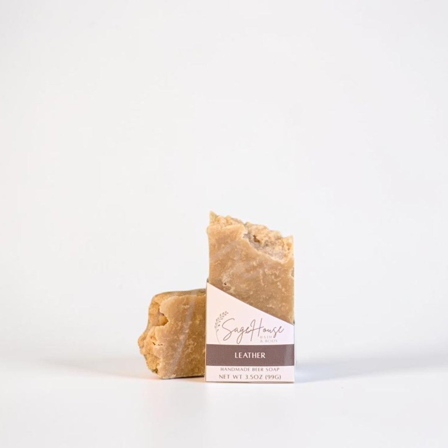 A labeled bar of soap sitting in front of a matching bar. On a white background.