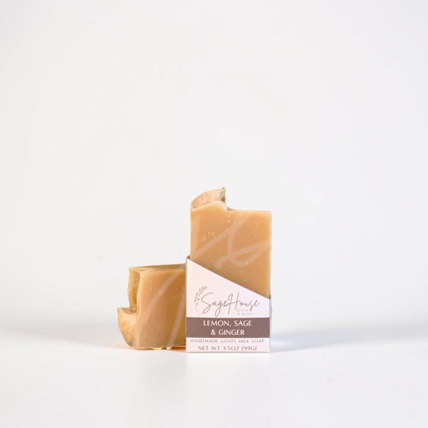 A labeled bar of soap sitting in front of a matching bar of soap. On a white background.