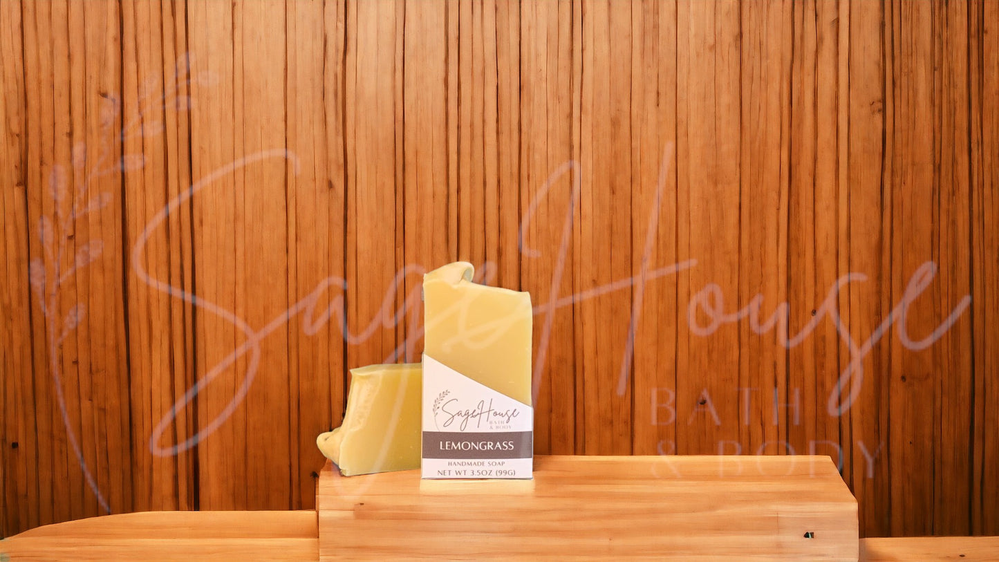 A yellow bar of soap in a white labeled box, on a wood surface.