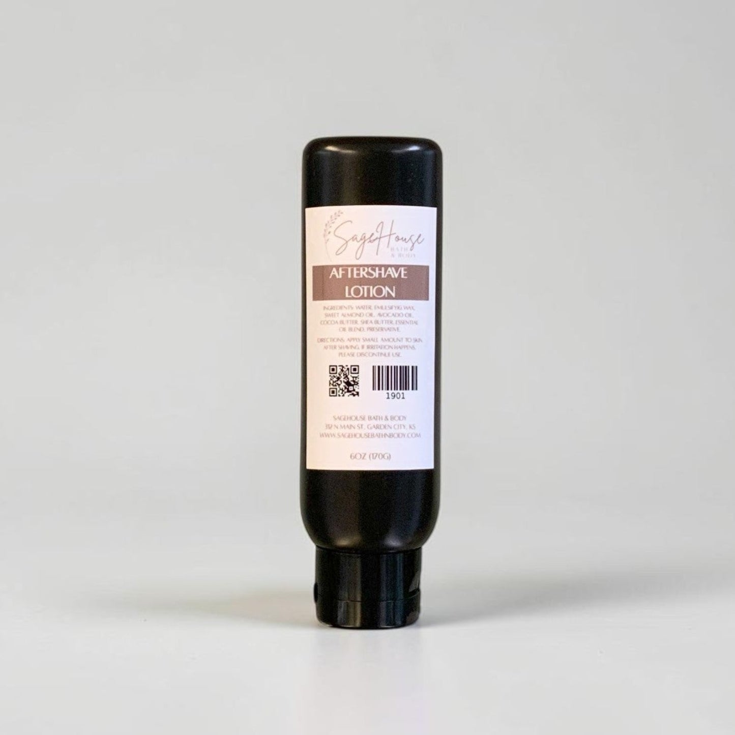 A single black plastic bottle of lotion standing upright against a neutral light gray background.