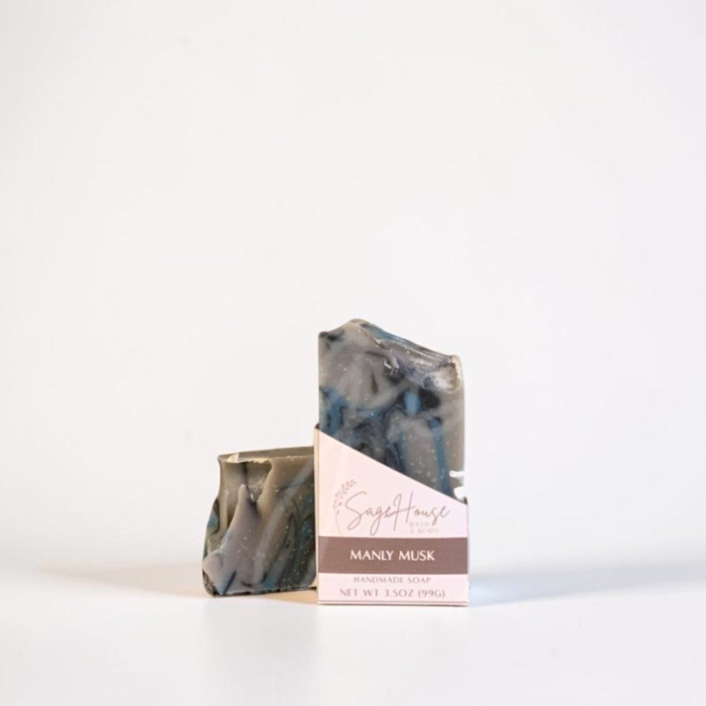 A labeled bar of soap sitting in front of a matching bar. On a white background.