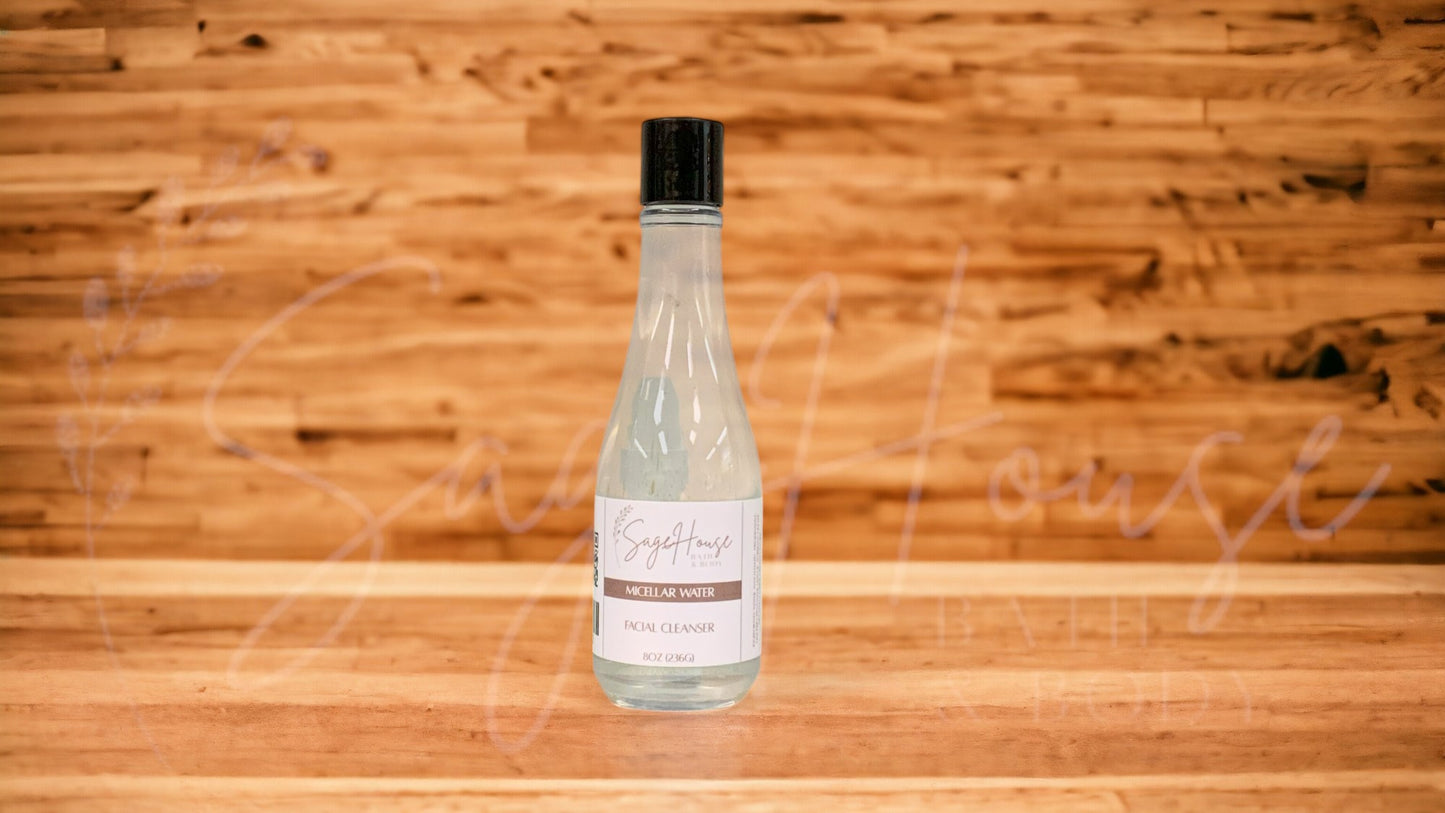 A transparent bottle with a black lid, placed on a wooden surface with a wooden background.