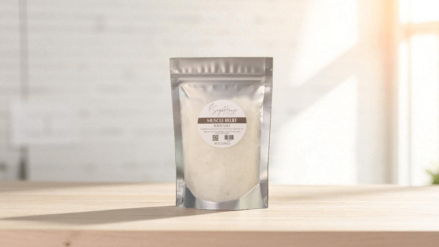 Silver packaging with a clear window of white salt labeled "muscle relief" on a wood surface.