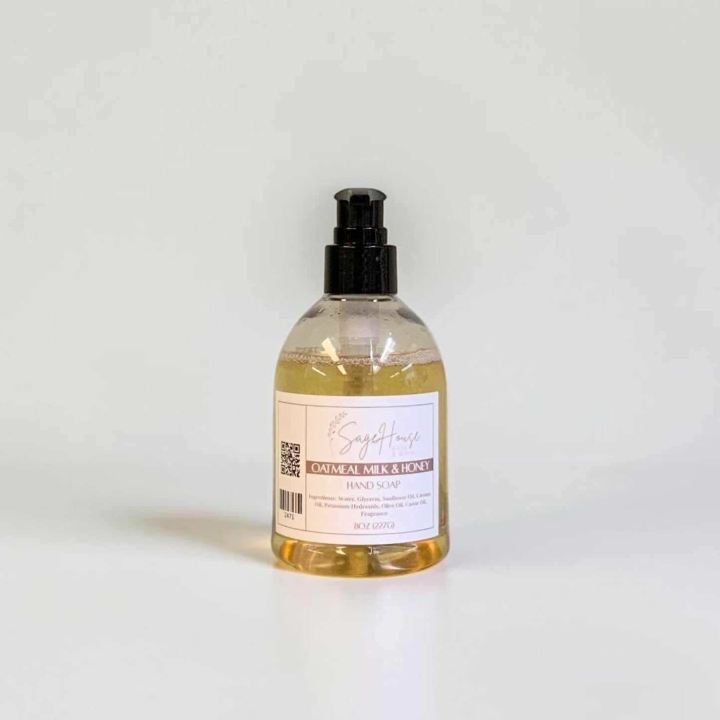 A bottle with black pump top and white label. On a white background.