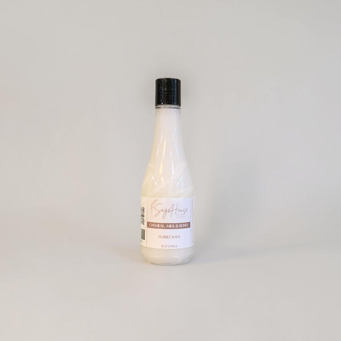 Bottle of bubble bath on a light gray background