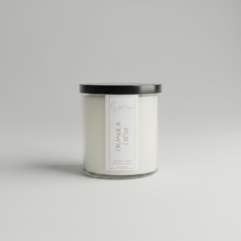 A white soy wax candle in a clear container, on a neutral background