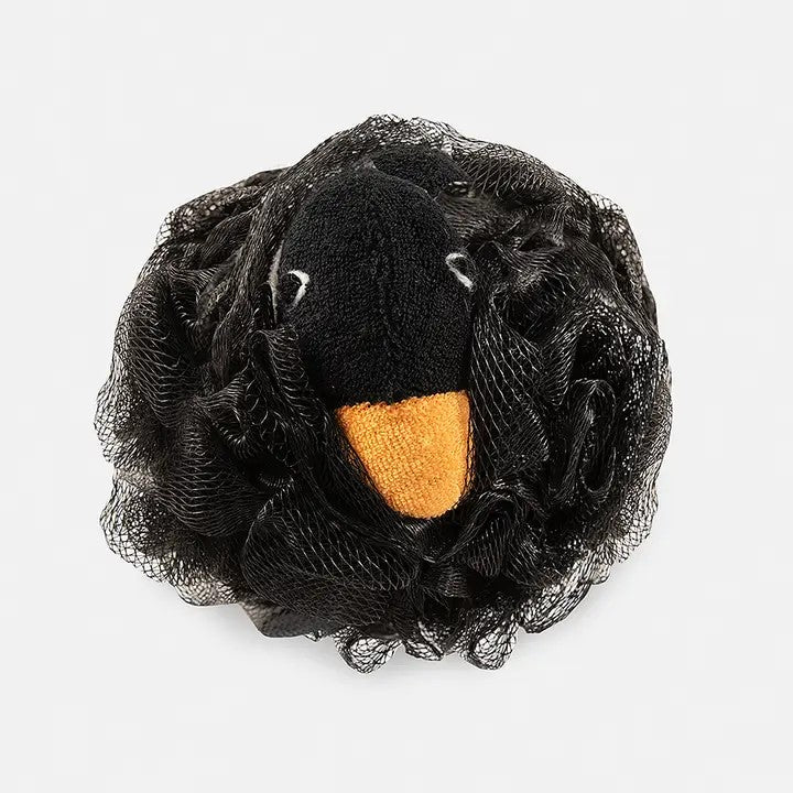 A black penguin-shaped scrubbie with a black and yellow face, designed for use as a bath sponge.