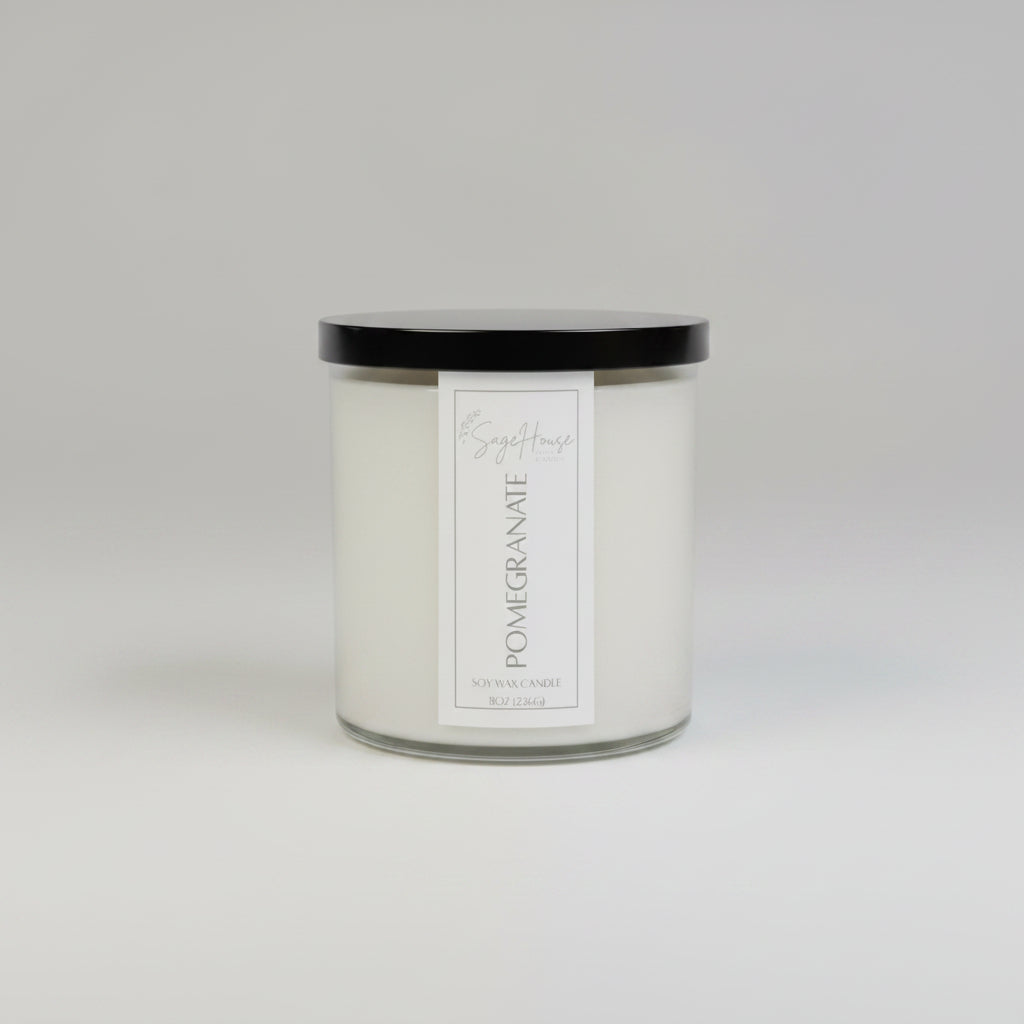 A white soy wax candle in a clear container, placed on a wooden surface, with a label on the front.