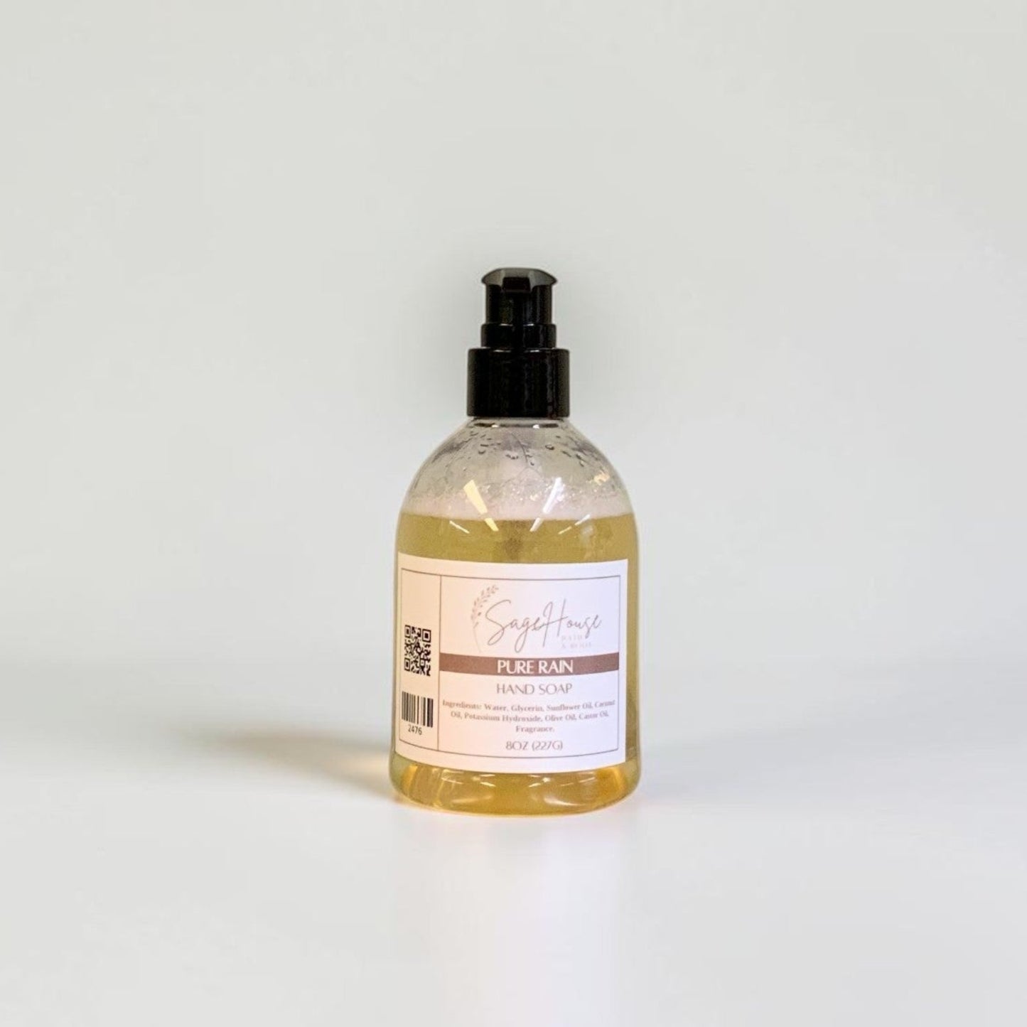 A bottle with black pump top and white label. On a white background.