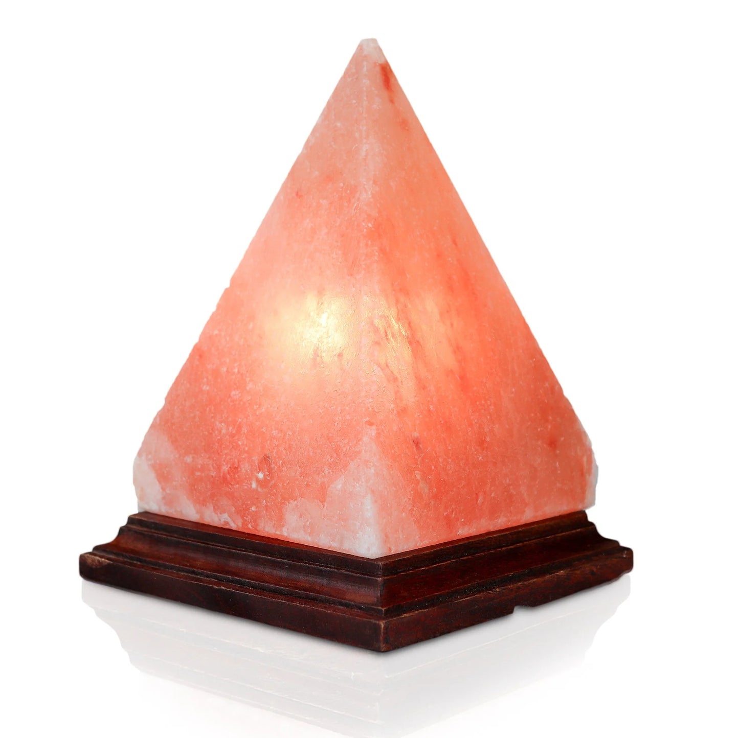 A triangular pyramid-shaped Himalayan salt lamp with a warm pink glow, placed on a wooden base.