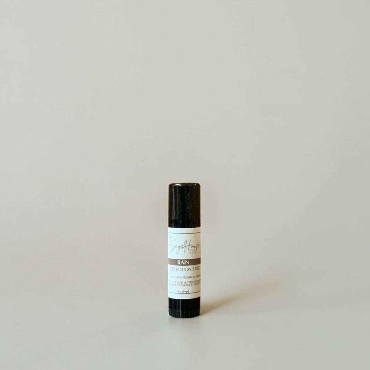A black tube with label on a light gray background